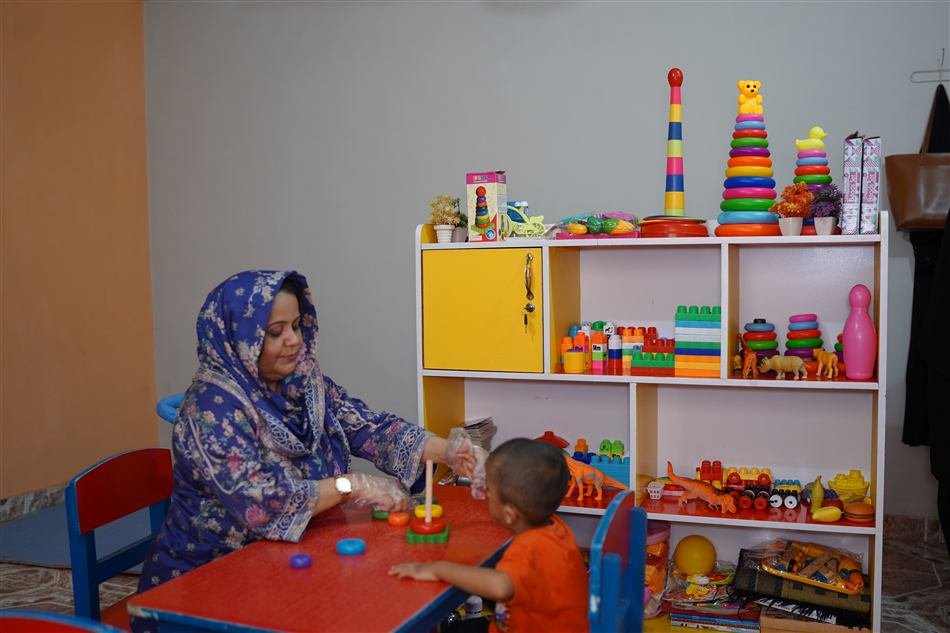 Therapist and child at the play therapy table