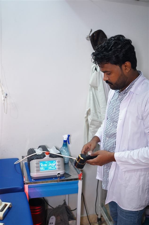 Staff member operating a laser therapy device