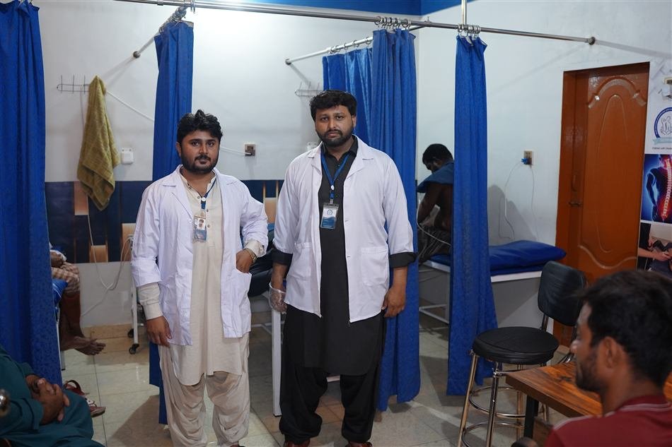 Two physiotherapy staff members in the treatment area